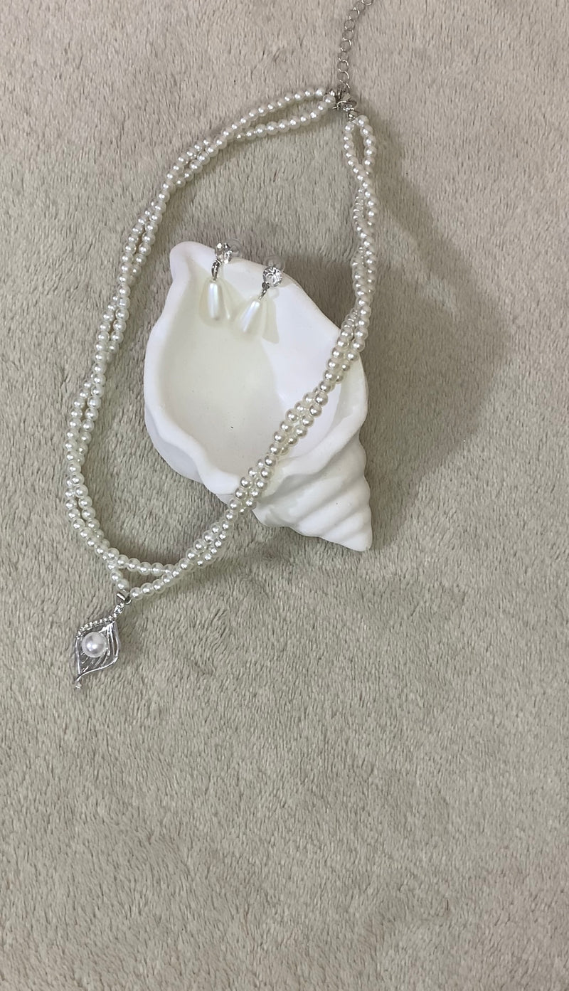 faux pearl necklace and teardrop earrings