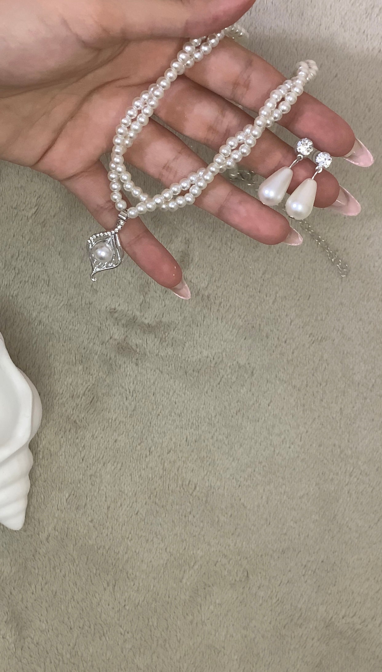 faux pearl necklace and teardrop earrings